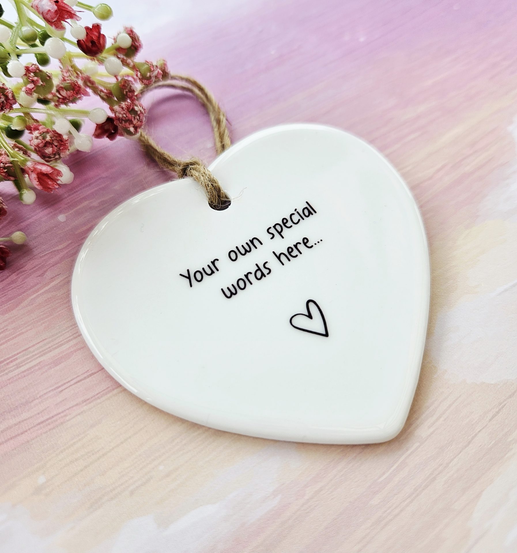 Personalised white ceramic heart decoration with custom text and rustic twine hanger