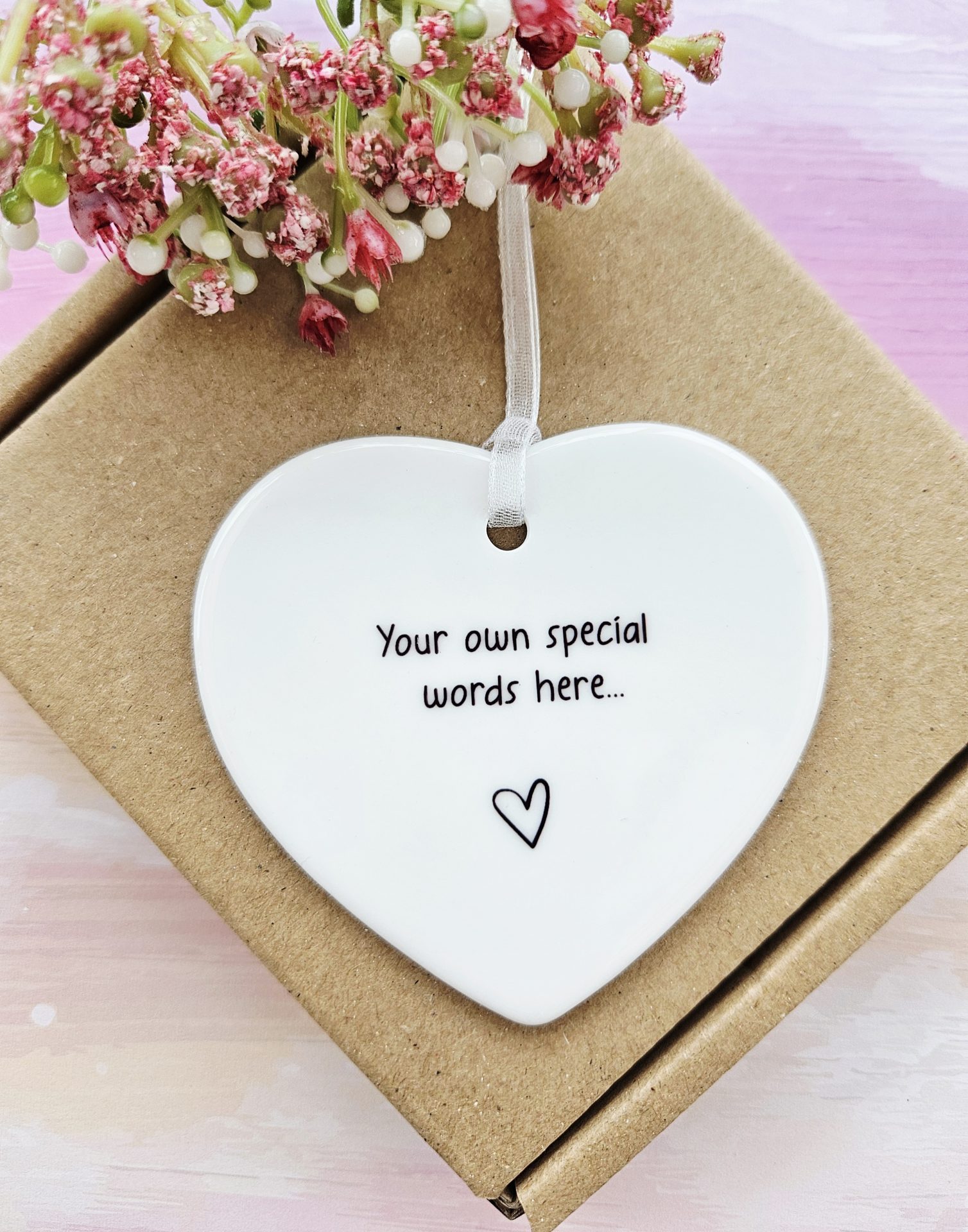 Personalised ceramic heart gift presented in kraft gift box with white ribbon hanger