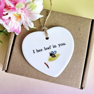Bee encouragement ceramic heart displayed on gift box
