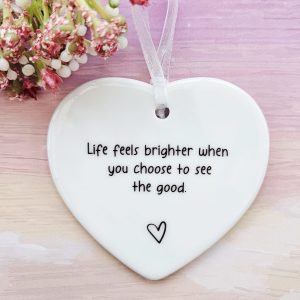 Ceramic heart keepsake displaying a positive quote.