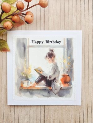 Fabric birthday card for book lovers with cosy girl reading illustration and stitched fabric panel