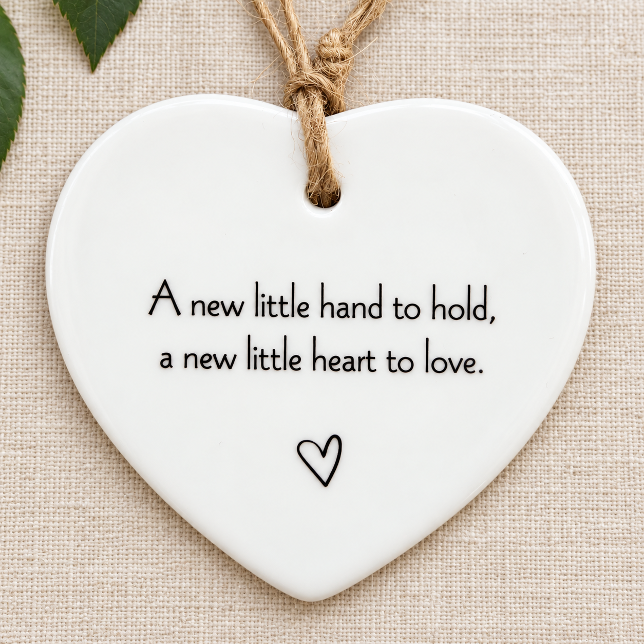 White ceramic heart ornament with a new little hand to hold quote and natural twine hanging loop, newborn baby gift and nursery keepsake