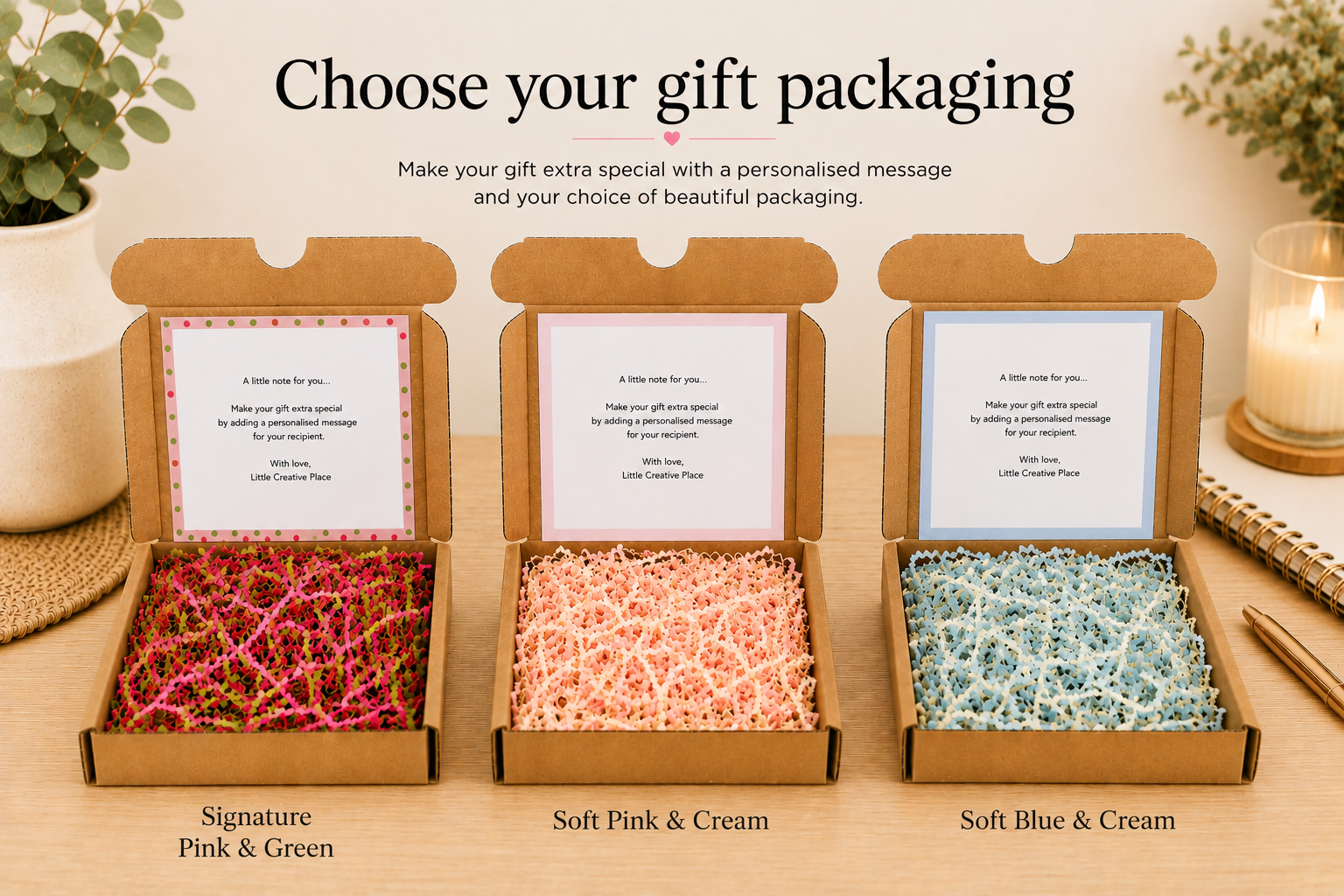 Graphic showing three gift packaging choices for ceramic heart keepsakes in open kraft boxes: Signature Pink & Green with matching shred and a polka dot message card, Soft Pink & Cream with pink and cream shred and a pink-bordered card, and Soft Blue & Cream with blue and cream shred and a blue-bordered card.