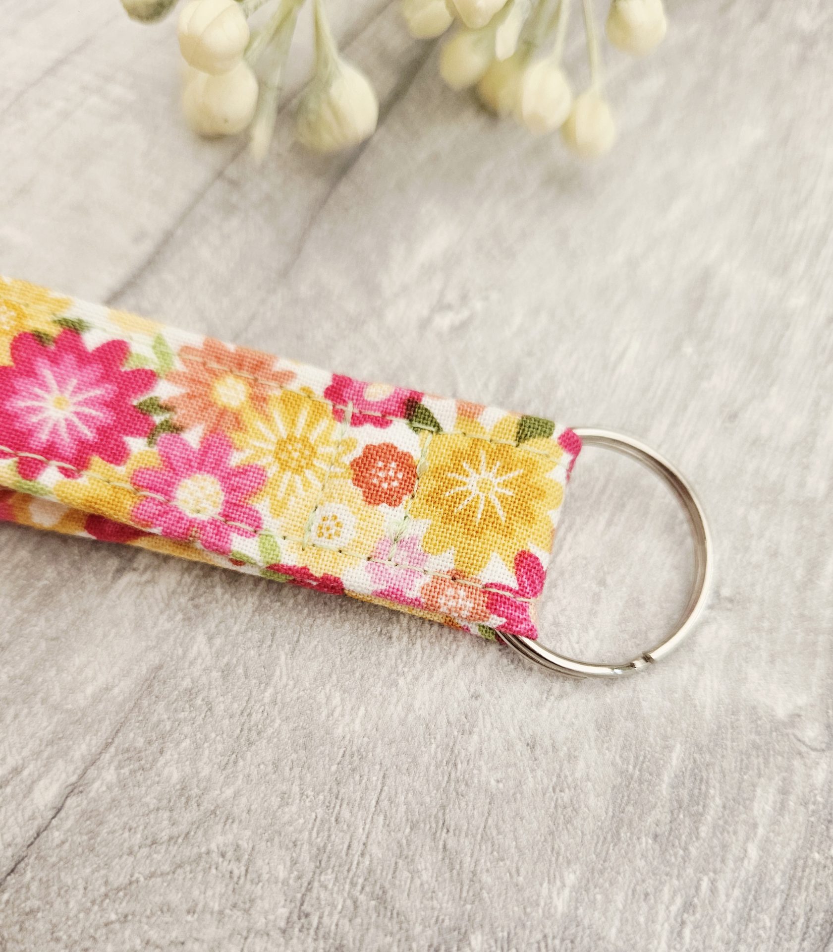 Close-up of the floral fabric wristlet showing the cotton print