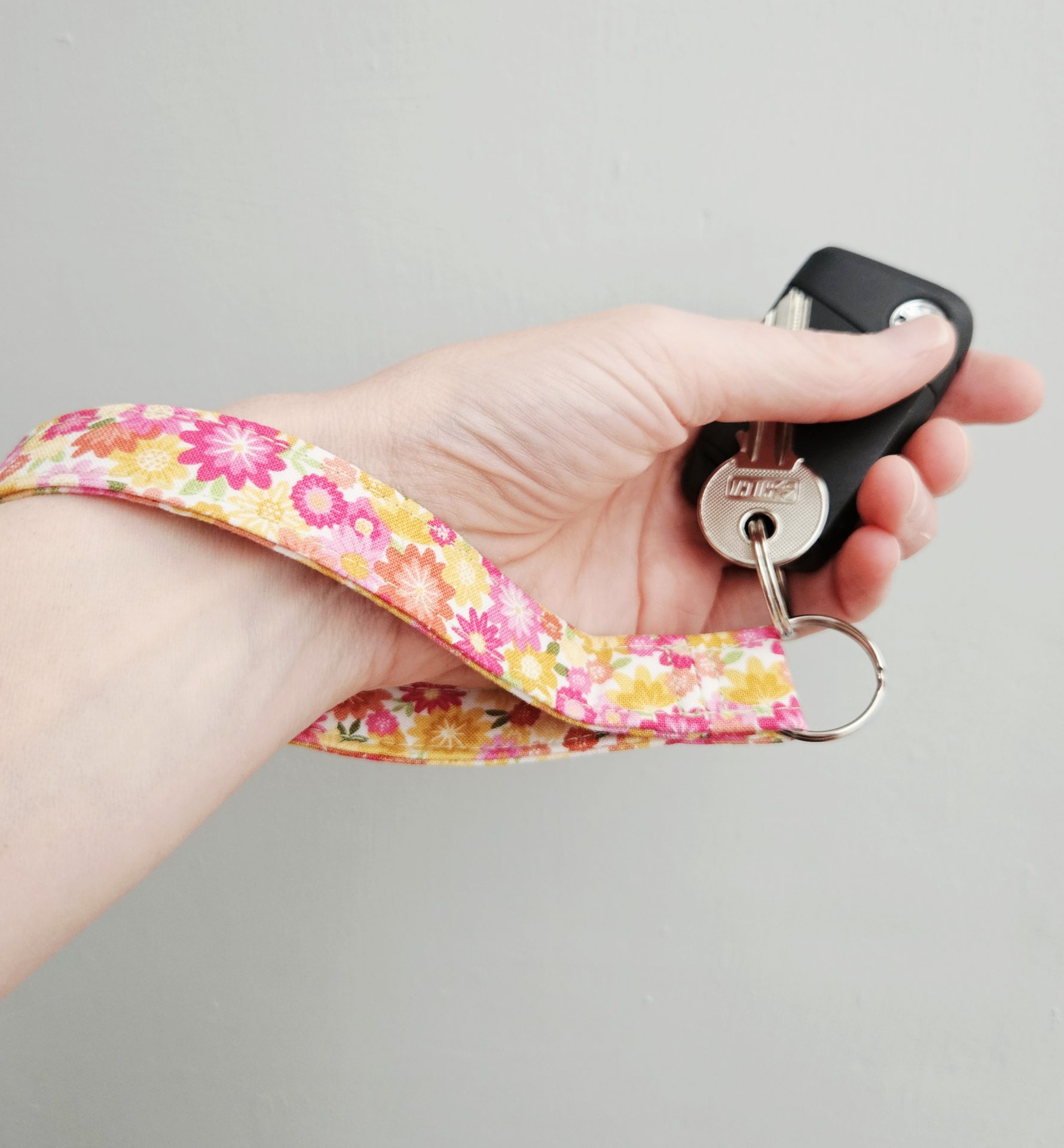 Floral fabric wristlet worn comfortably on the wrist