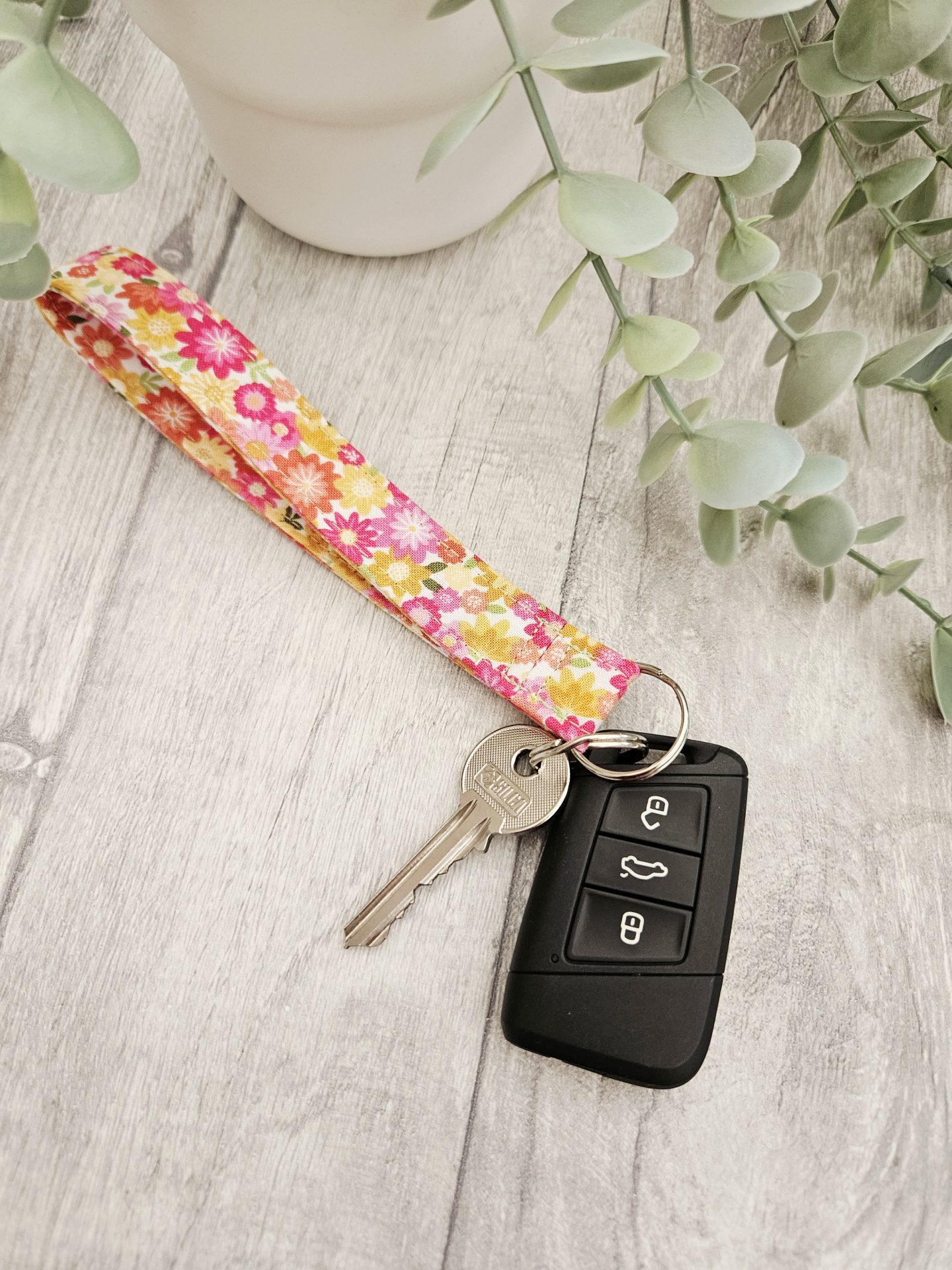 Handmade floral fabric wristlet with house keys and car key