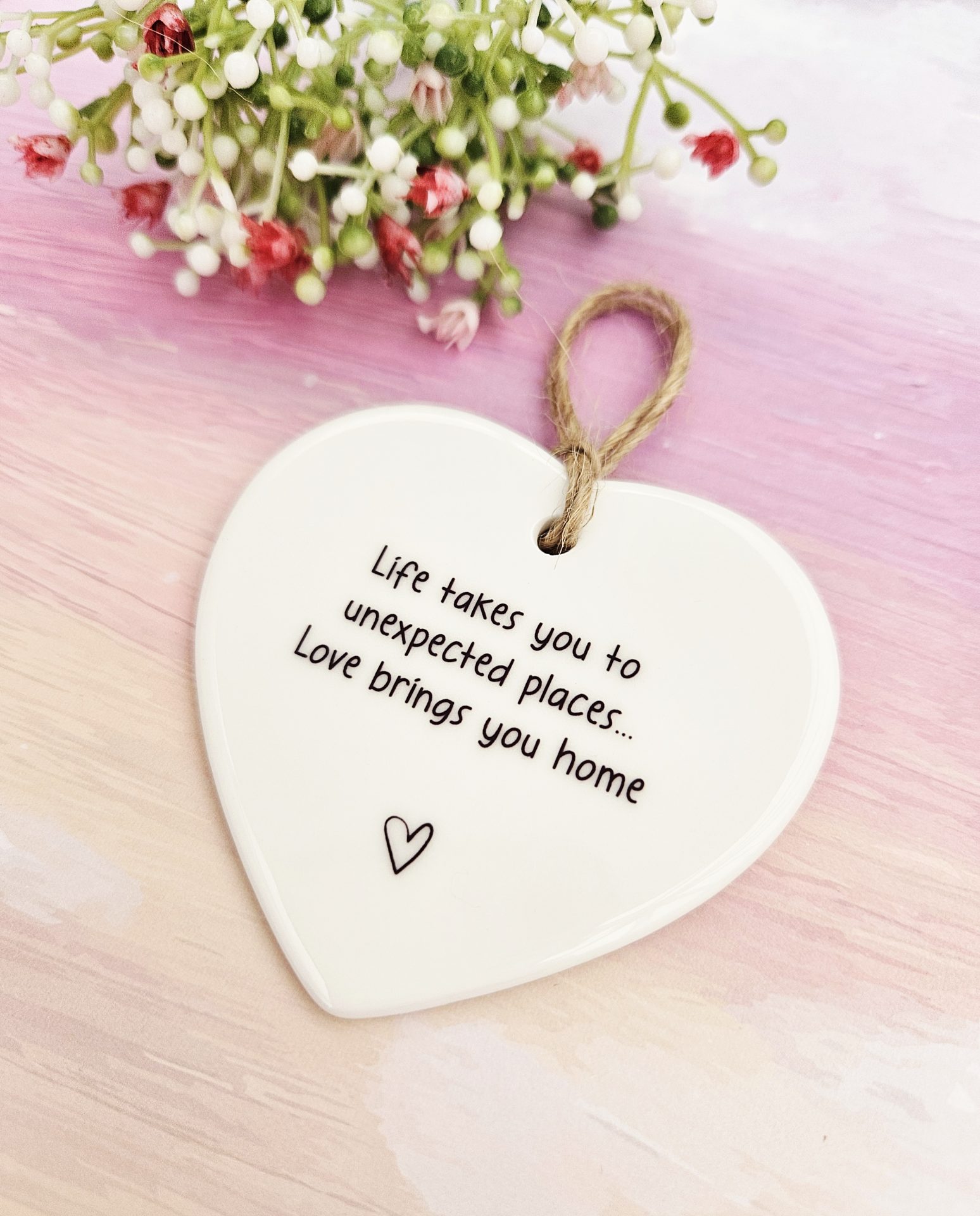 Life takes you to unexpected places, love brings you home ceramic heart close-up view