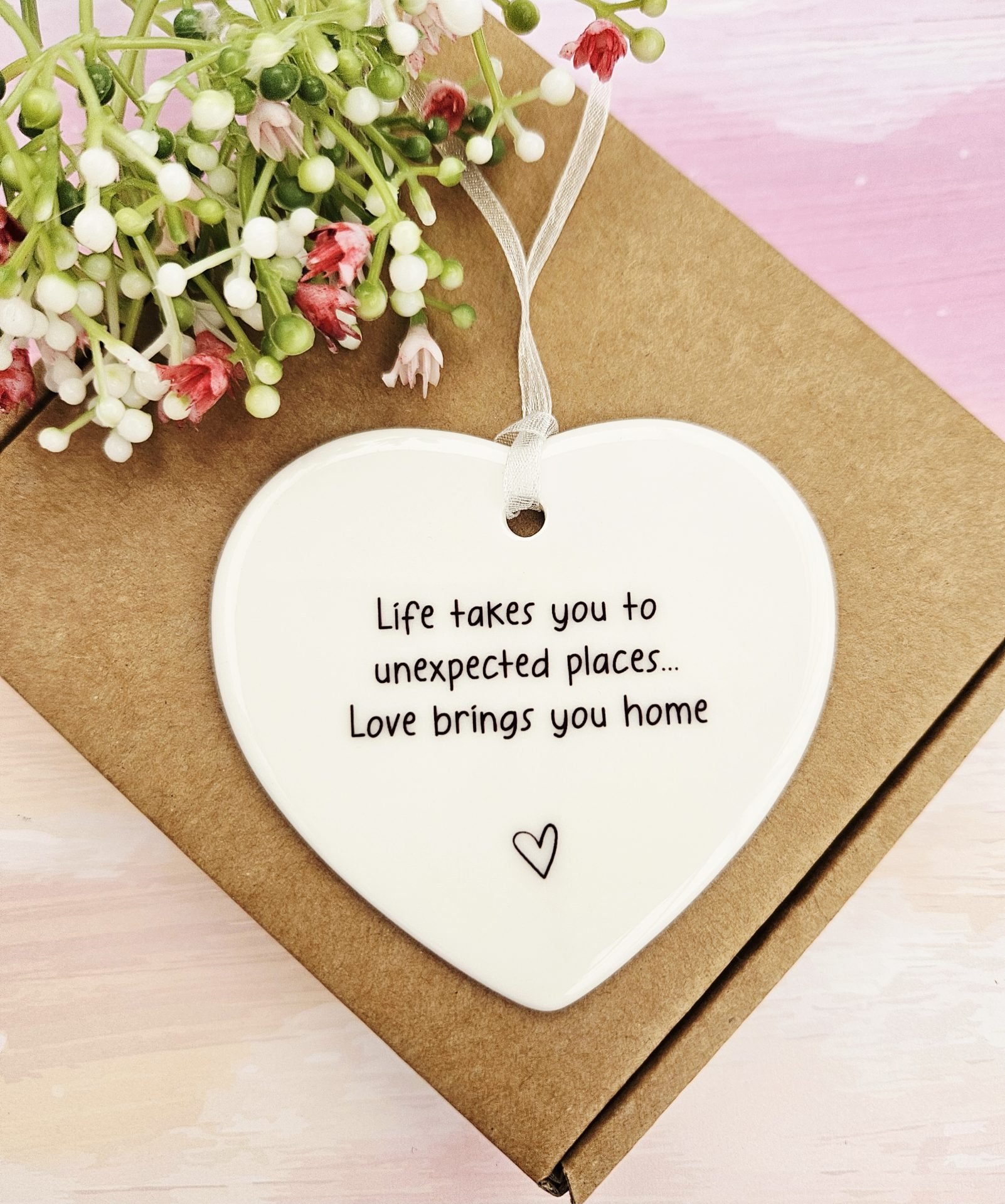 Ceramic heart keepsake resting on a presentation gift box with floral styling