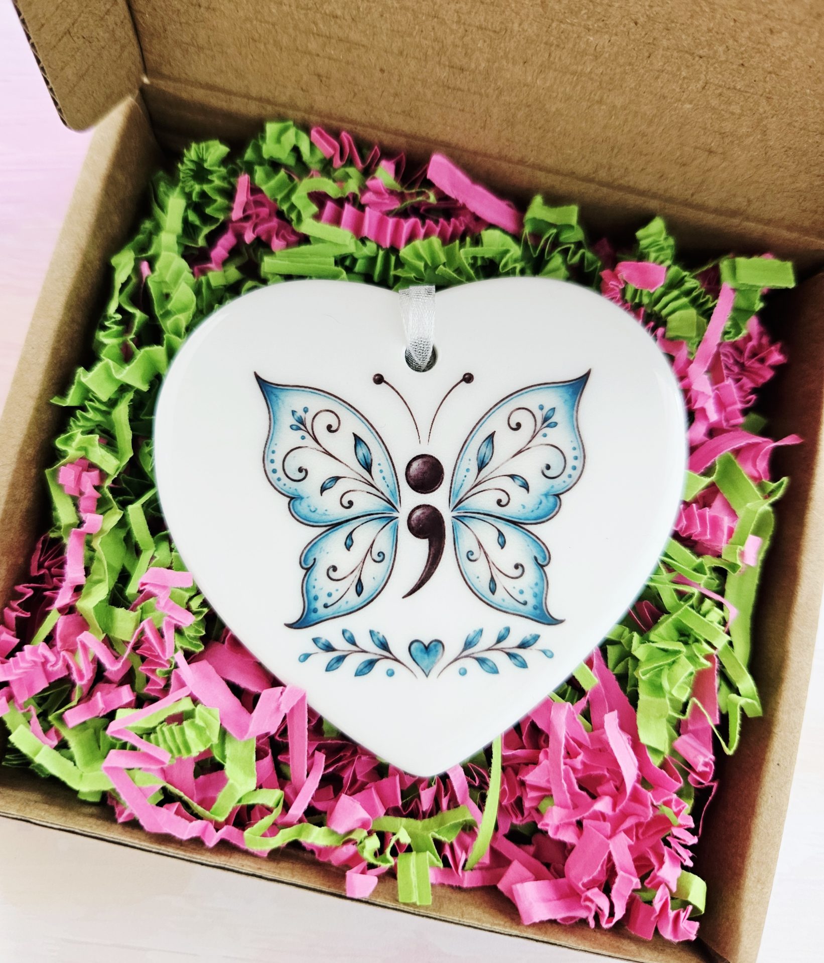 Semicolon Butterfly Ceramic Heart presented in a gift box with signature pink and green shredded paper