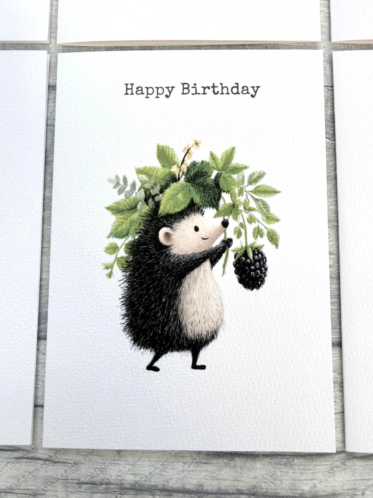 Woodland hedgehog birthday card featuring a blackberry and leafy foliage illustration