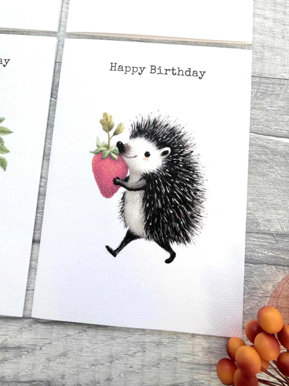A6 hedgehog birthday card with strawberry illustration printed on textured white card