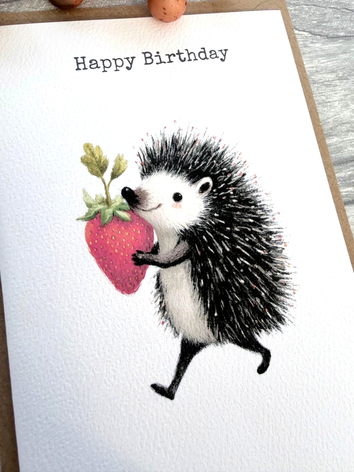 Handmade hedgehog birthday card featuring a cute strawberry woodland illustration
