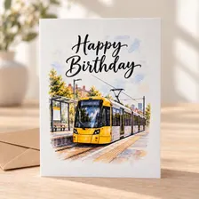 Manchester tram birthday card featuring a yellow tram at a tram stop in a watercolour-style illustration, with Happy Birthday lettering.