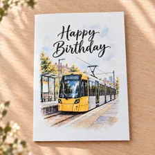Watercolour style Manchester tram birthday card featuring a yellow tram and Happy Birthday lettering, handmade for transport enthusiasts.